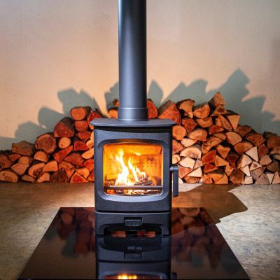 Charnwood Aire 3 Woodburning Stove in front of logs