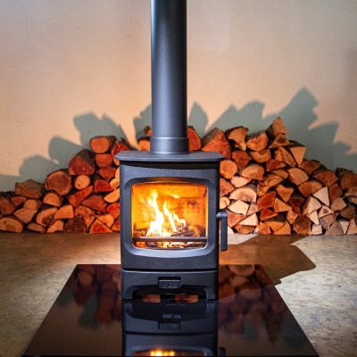Charnwood Aire 3 Woodburning Stove in front of logs